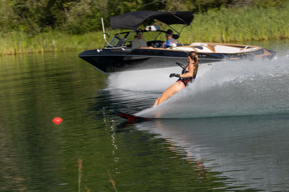 Tournament tow boat pulling a slalom skier through the course