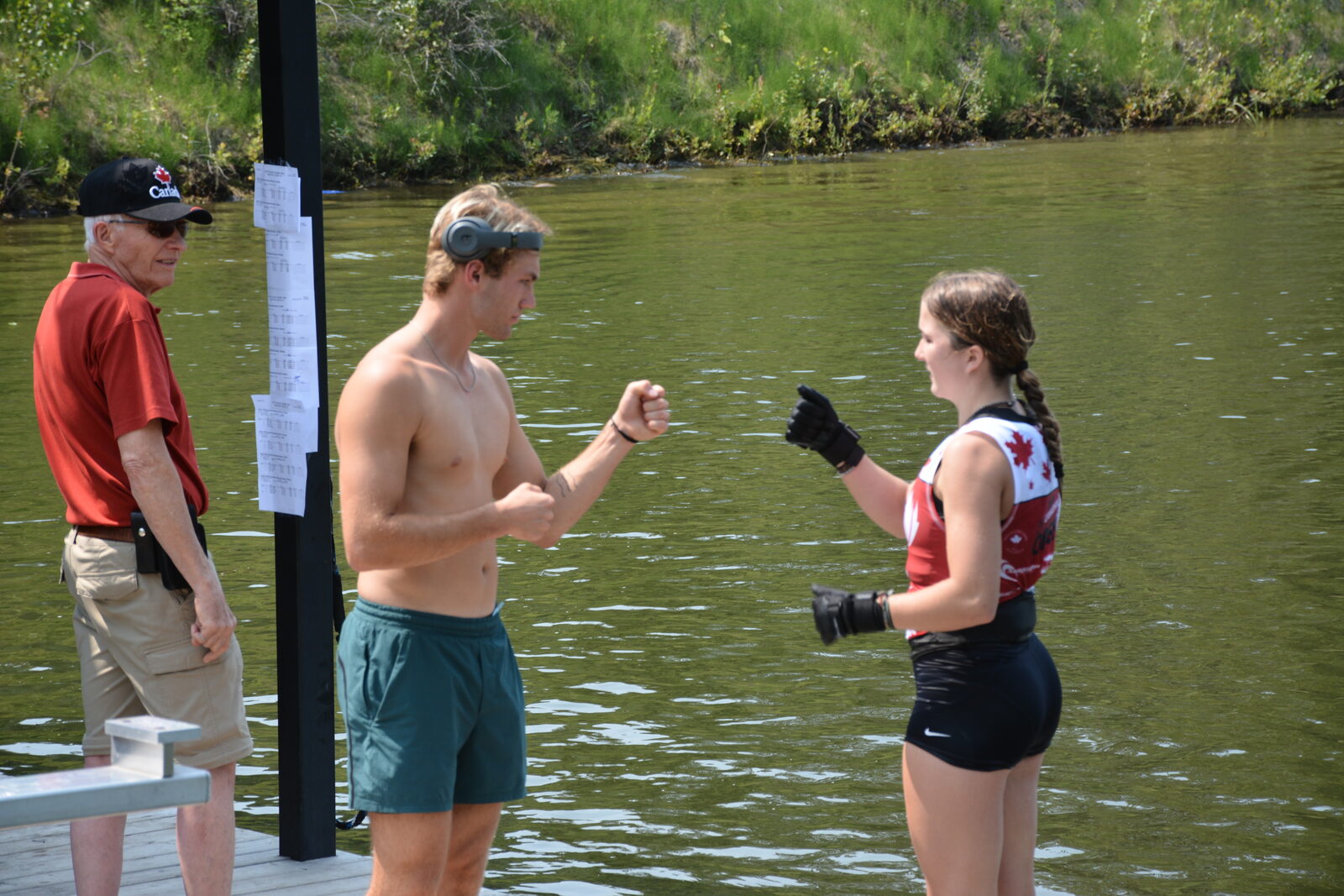 Coach Sean Kraus fist-bumping a skier on the dock before a training set at Shalom Park