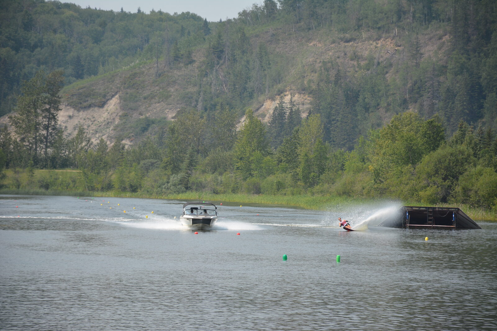 Wide view of the Shalom Park competition slalom course with the North Saskatchewan River valley bluffs behind