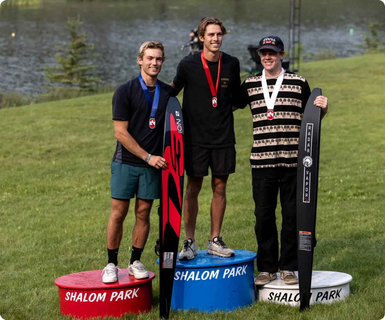 Three men standing on top of a podium.