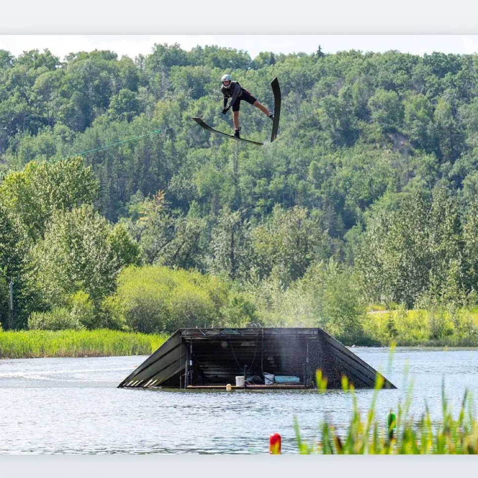 A person jumping over an object in the water.