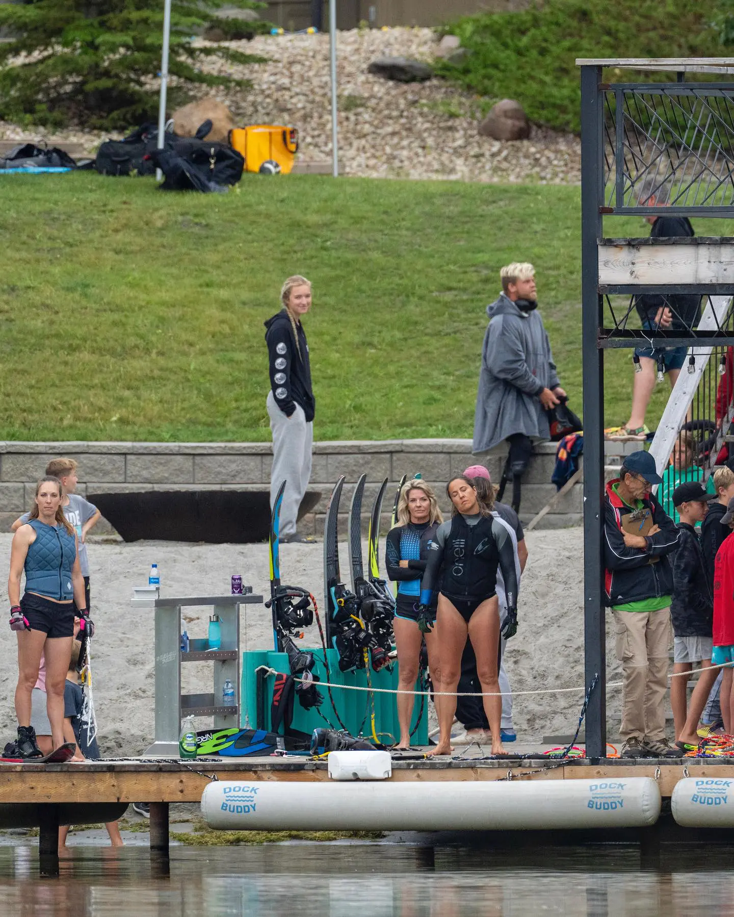 A group of people standing around on the dock