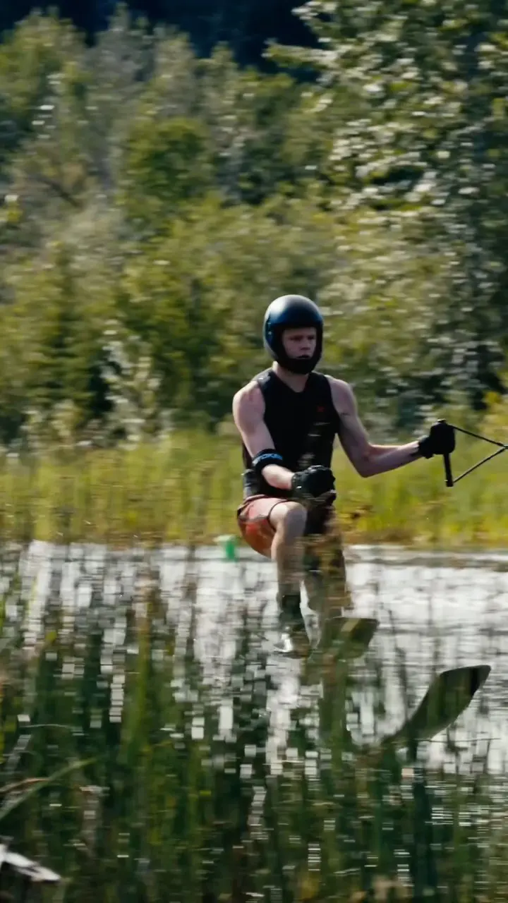 A person in the water with a helmet on.