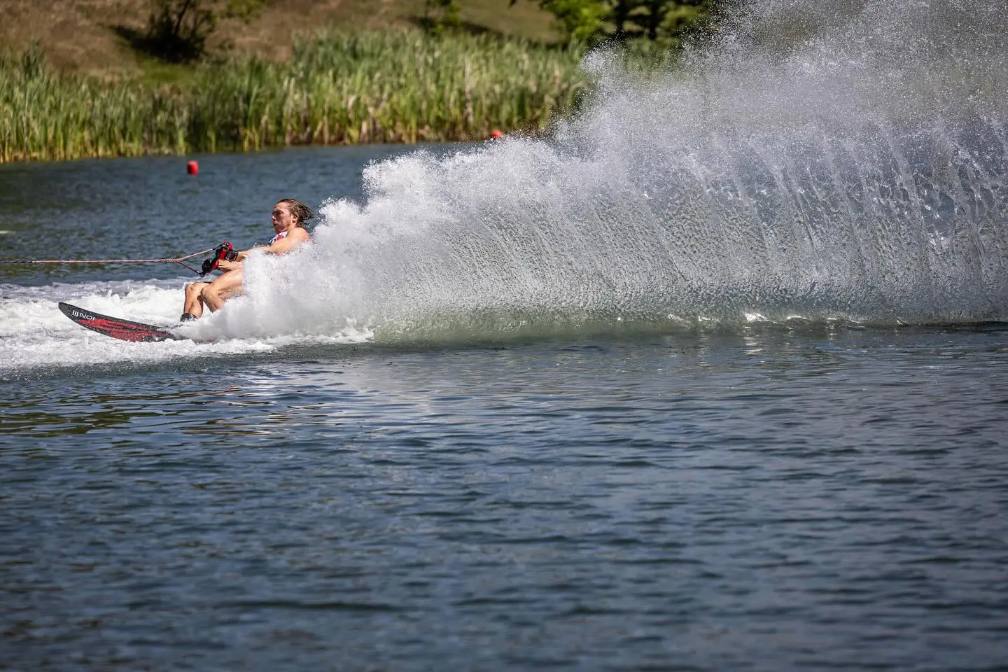 A person on skis is being pulled by a boat.