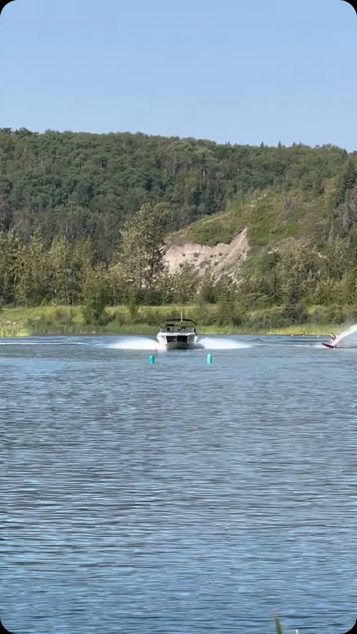 A boat is in the water with two people on it.