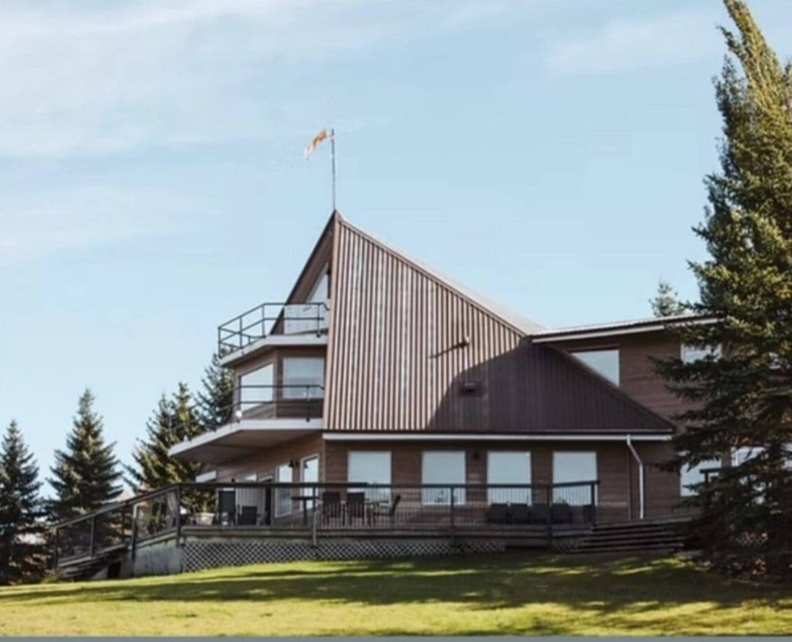 A large wooden house with a flag on the top of it.