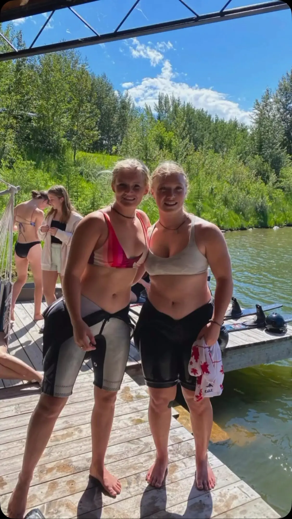 Two women standing next to each other on a dock.