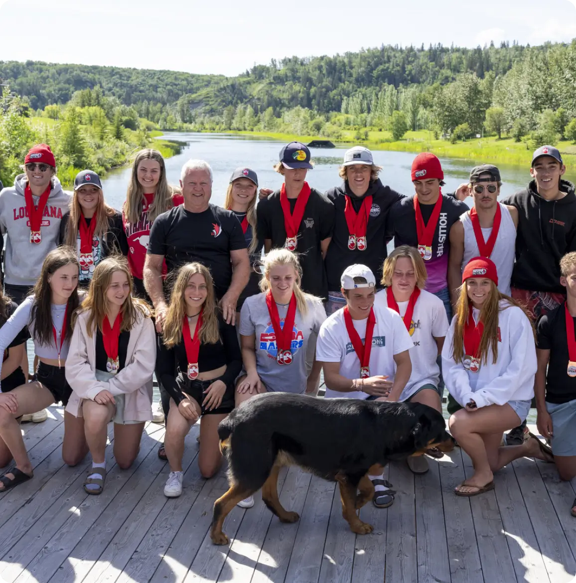 A group of people and their dog posing for a picture.