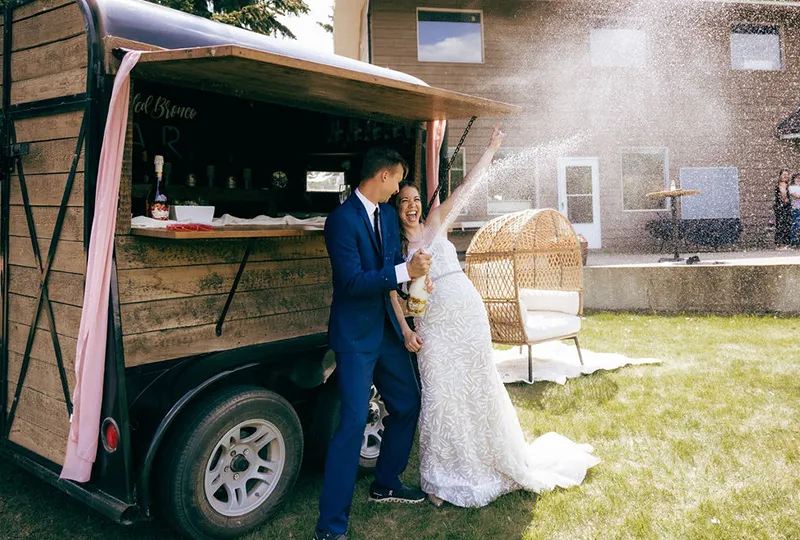 A man and woman standing in front of an outdoor wedding.