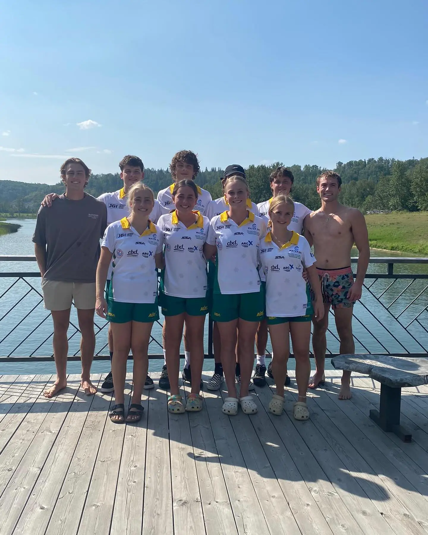 A group of people standing on top of a dock.