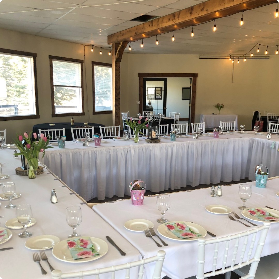 A large banquet hall with tables and chairs.