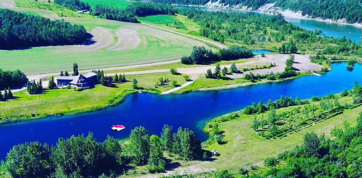 A river with trees and grass in the background