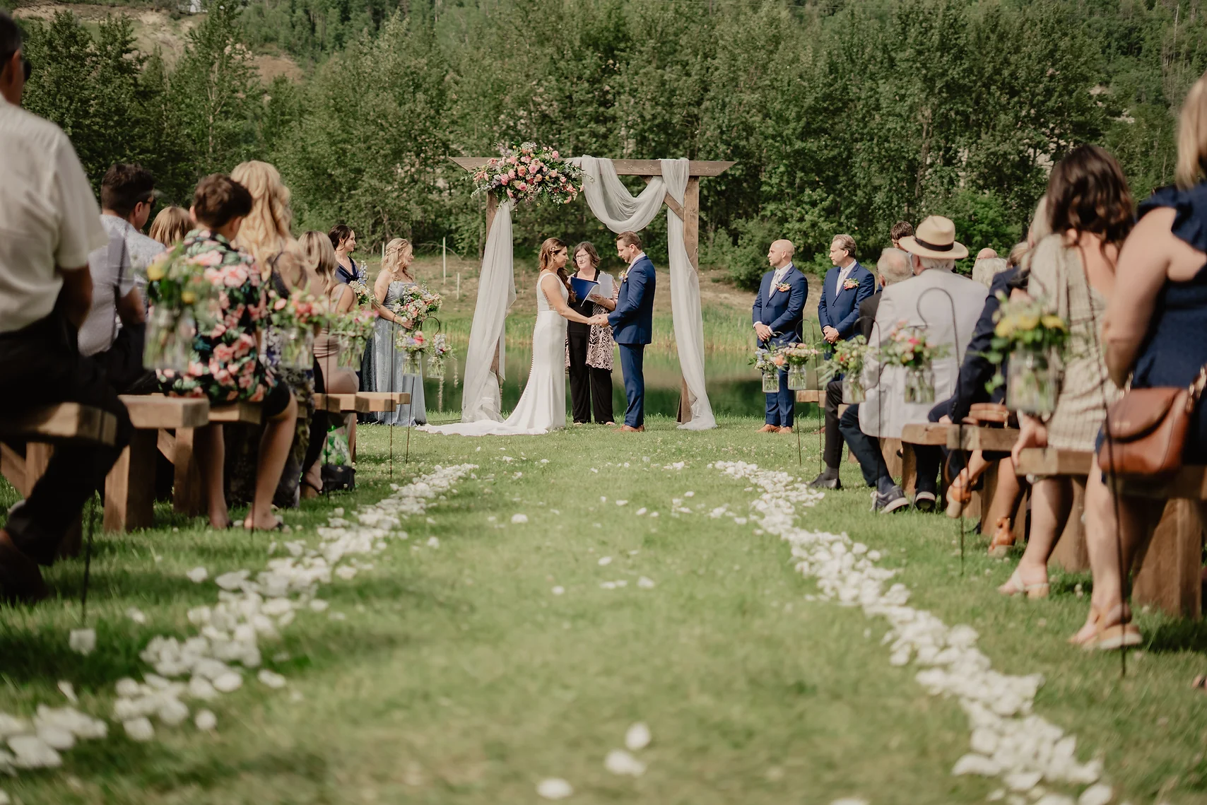 A wedding ceremony with many people standing around.