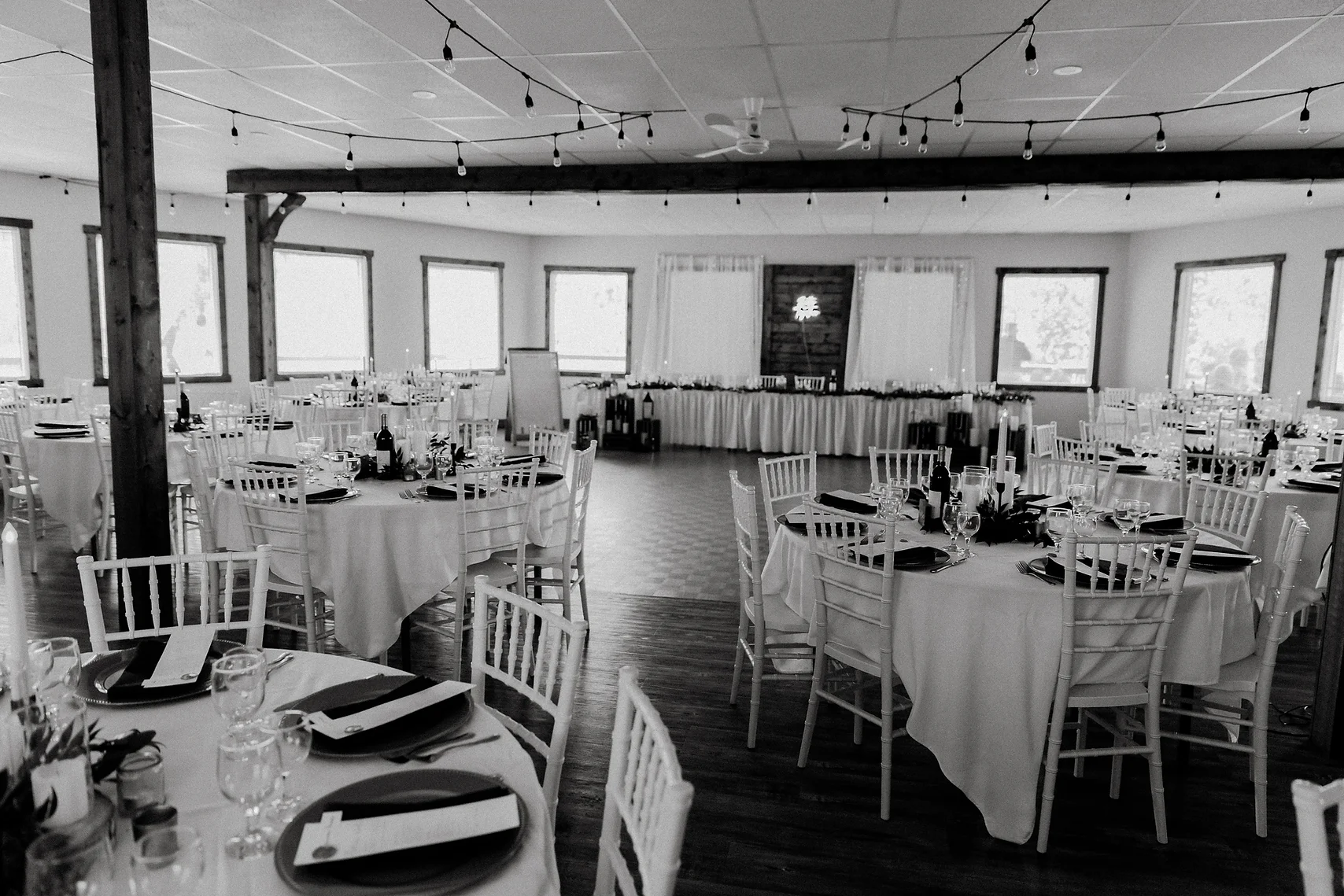 A black and white photo of tables in a room.