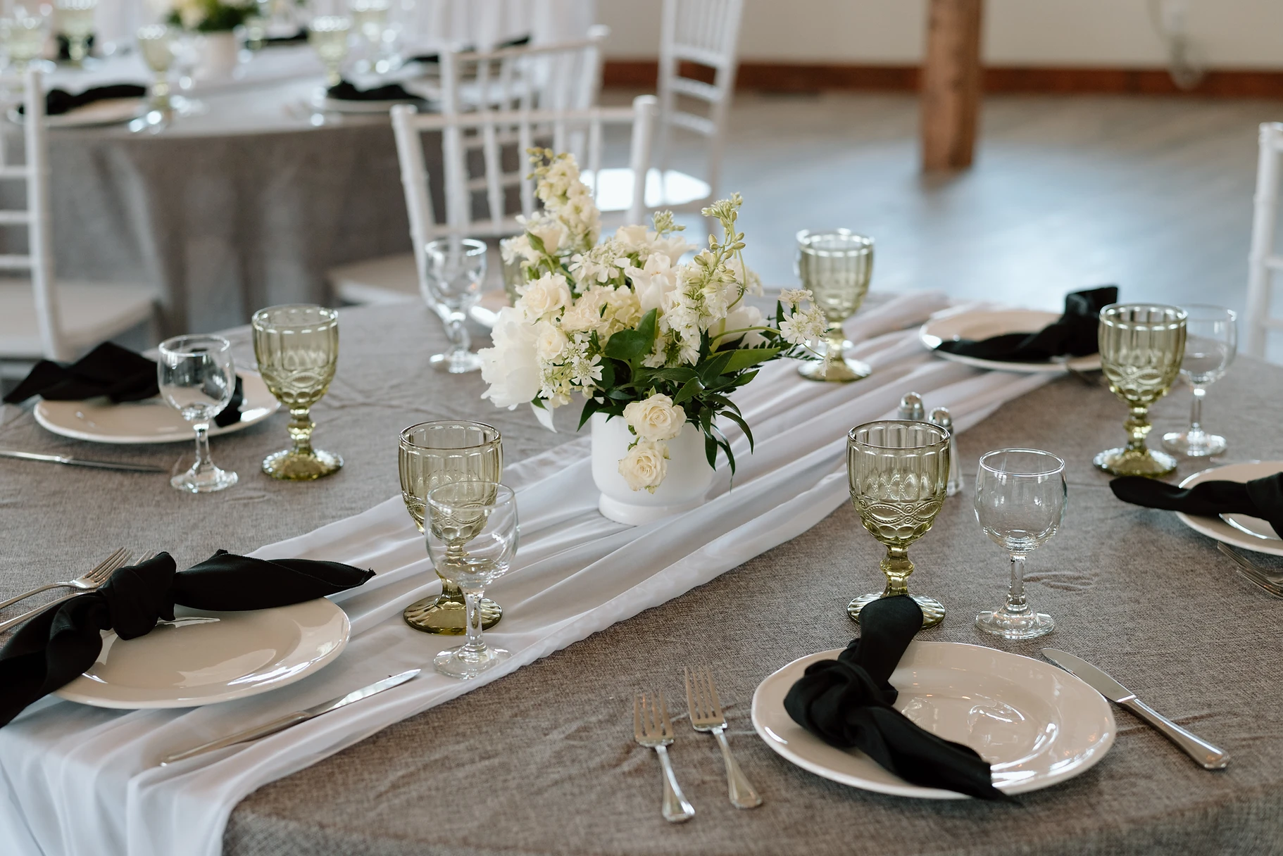 A table set with plates, silverware and glasses.