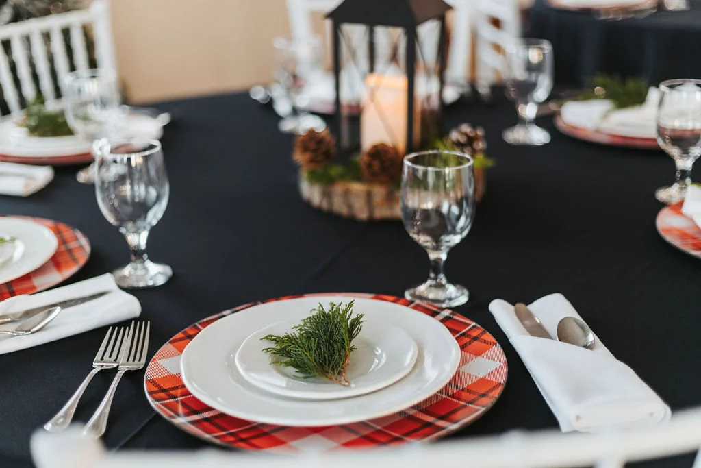 A table set with plates and glasses on top of it.