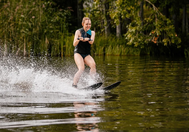 A woman is water skiing on the lake.