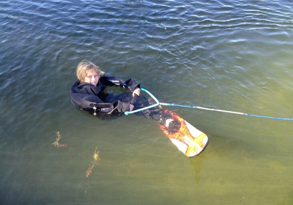 A person in the water holding onto a rope